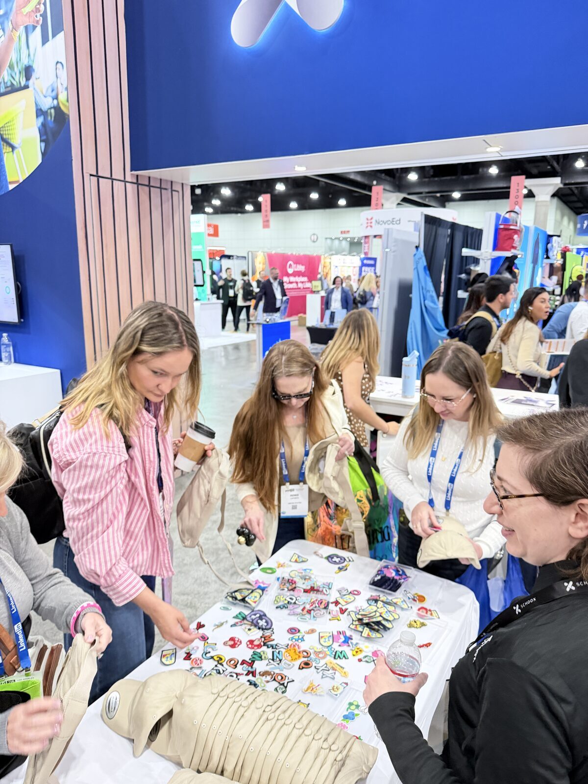 Guests personalizing merch at a hands-on craft table during a private party