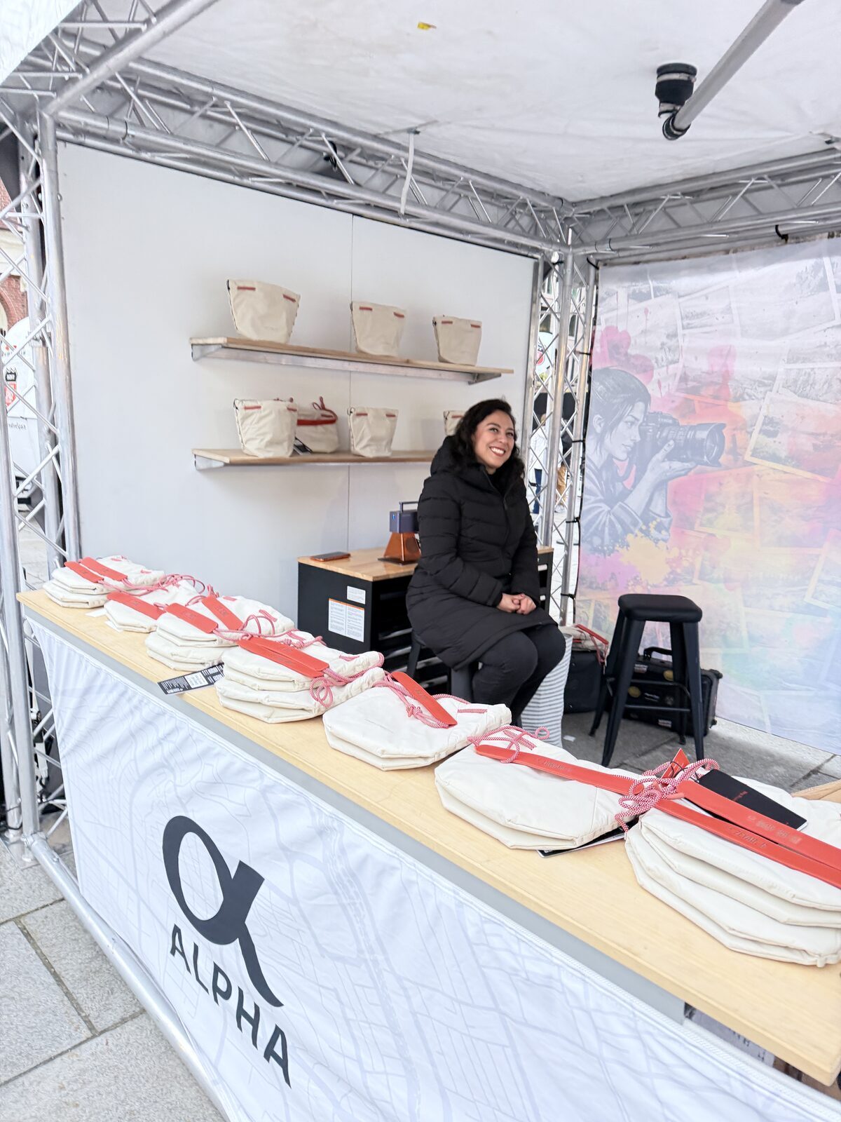 Outdoor trailer print station set up on the grass at a daytime festival activation